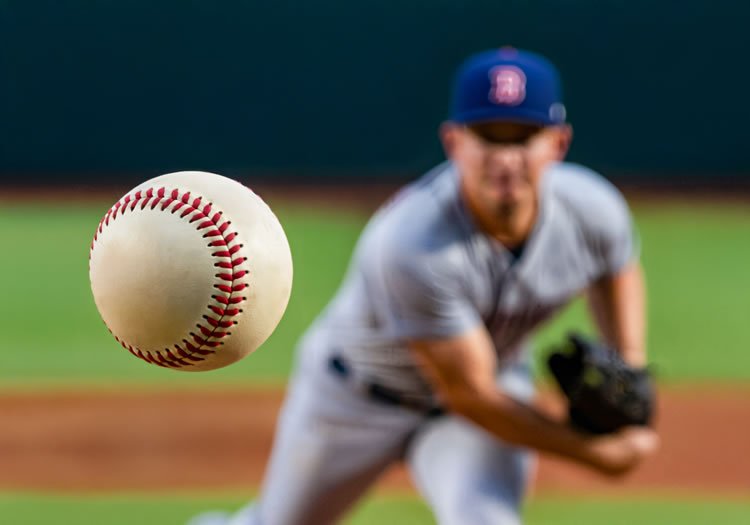 Pitcher throwing baseball during game