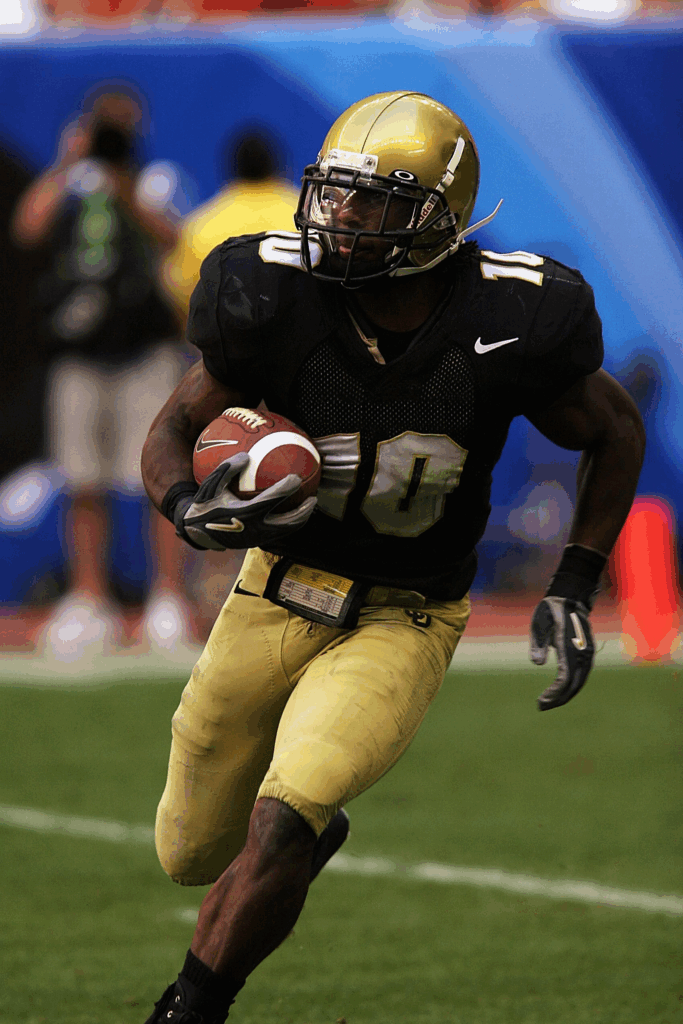 American football player running with the ball.