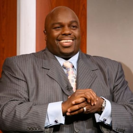Smiling man in a suit on TV set