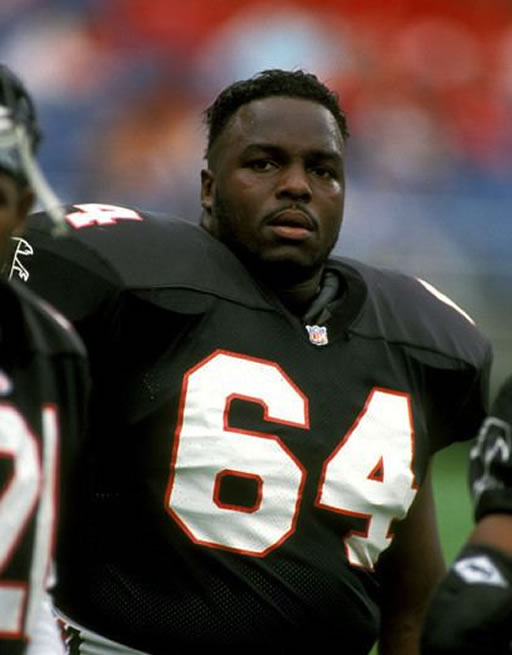 Football player wearing black jersey number 64